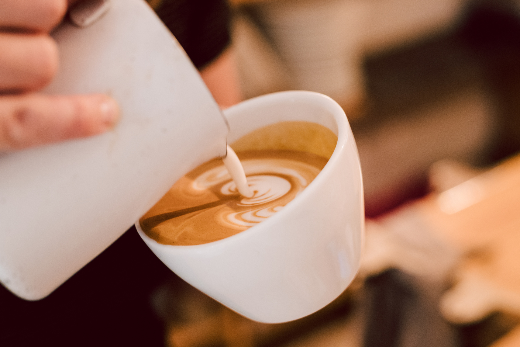 Barista making coffee in the kitchen